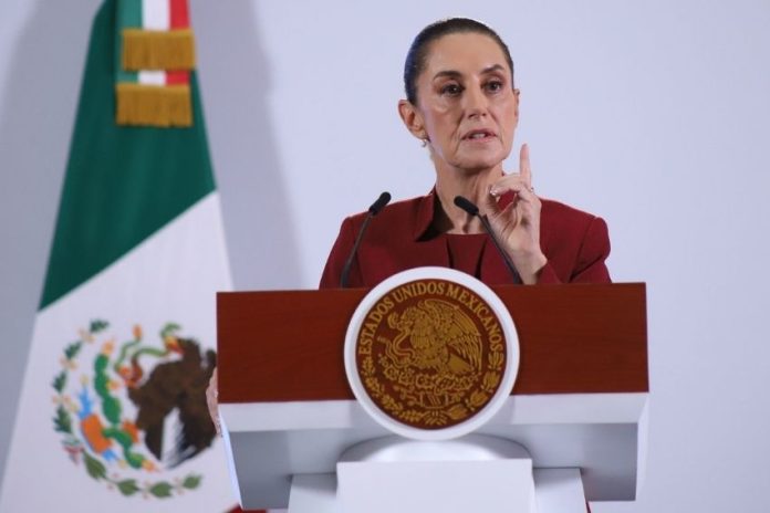 Mexican President Claudia Sheinbaum addresses tariffs on Mexico at a podium during her daily press conference