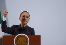 Mexico's President Claudia Sheinbaum at a podium talking to reporters about Mexico's national water plan at a press conference.