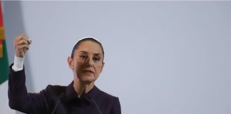 Mexico's President Claudia Sheinbaum at a podium talking to reporters about Mexico's national water plan at a press conference.