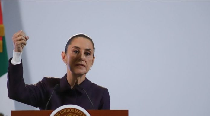 Mexico's President Claudia Sheinbaum at a podium talking to reporters about Mexico's national water plan at a press conference.