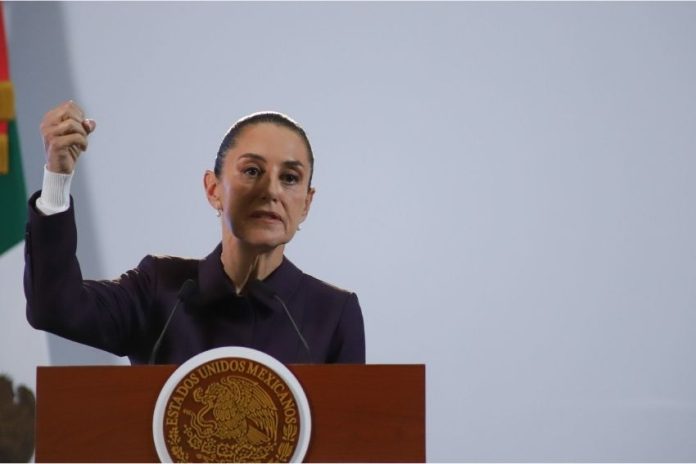 Mexico's President Claudia Sheinbaum at a podium talking to reporters about Mexico's national water plan at a press conference.