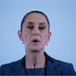 Close up of Mexico's President Sheinbaum's face in mid speech against a bokeh background