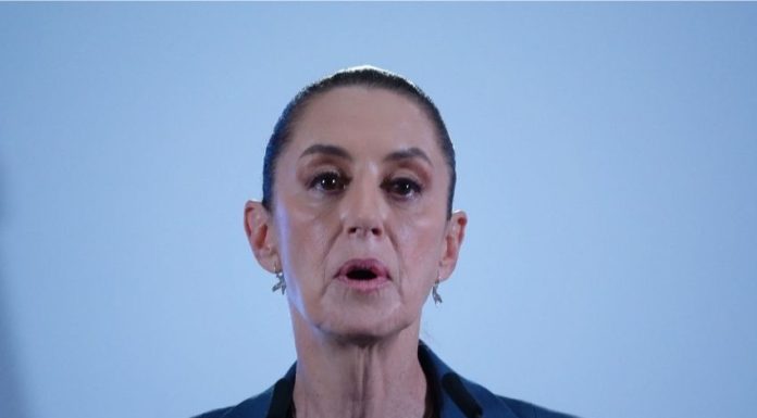 Close up of Mexico's President Sheinbaum's face in mid speech against a bokeh background