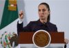 President Claudia Sheinbaum holds up her closed right hand while making a point while standing at the presidential podium during her Nov. 21 press conference at Mexico's National Palace.