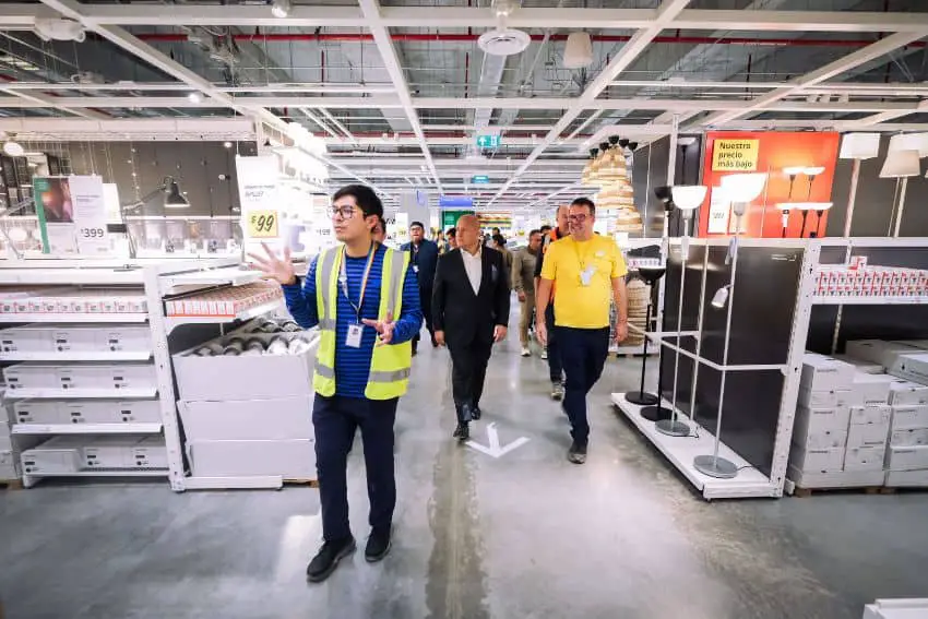 People walking through an aisle of an IKEA store in Guadalajara, Mexico, surrounded by shelves of IKEA products.