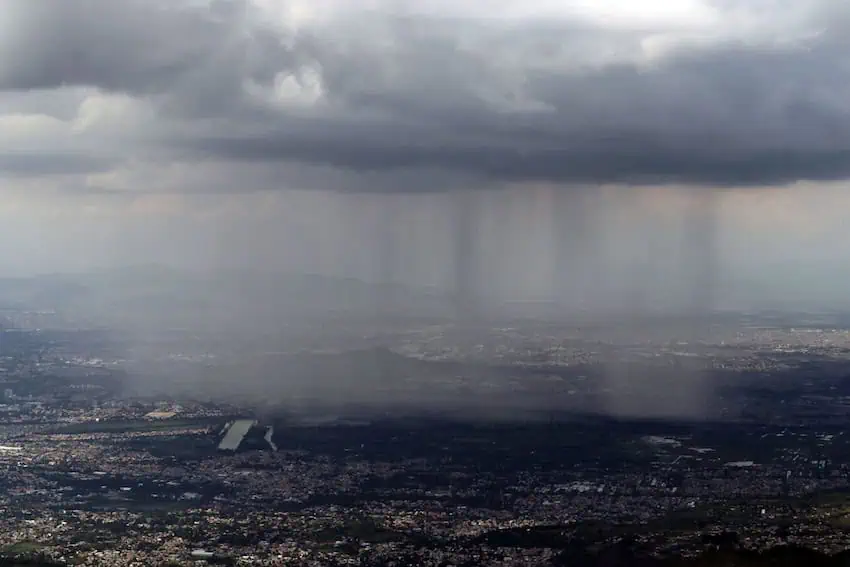 A curtain of rain falls on the canals of the Xochimilco district.