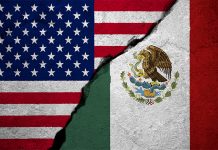 U.S. and Mexican flags with a concrete-like crack running between them.