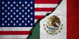 U.S. and Mexican flags with a concrete-like crack running between them.
