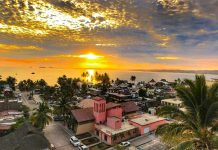 An aerial view of a sunset over the palm-filled seaside town of La Manzanilla, on the Costalegre of Jalisco in Mexico