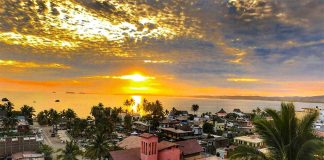 An aerial view of a sunset over the palm-filled seaside town of La Manzanilla, on the Costalegre of Jalisco in Mexico