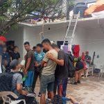 A group of migrants gather in the courtyard of a compound in Oaxaca, shortly after their rescue by government officials