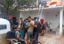 A group of migrants gather in the courtyard of a compound in Oaxaca, shortly after their rescue by government officials