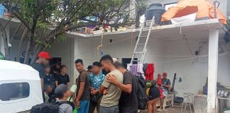 A group of migrants gather in the courtyard of a compound in Oaxaca, shortly after their rescue by government officials