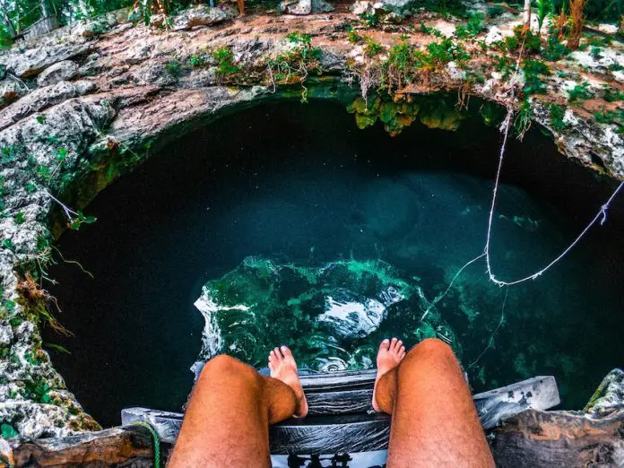 Someone entering a cenote in Mexico