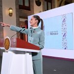 President Claudia Sheinbaum points to the audience from her podium during her morning press conference