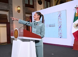 President Claudia Sheinbaum points to the audience from her podium during her morning press conference