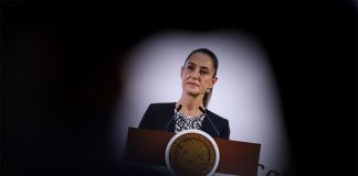 President Sheinbaum on stage in a spotlight