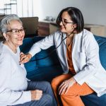 A doctor cares for an elderly patient. Healthcare in Mexico podcast