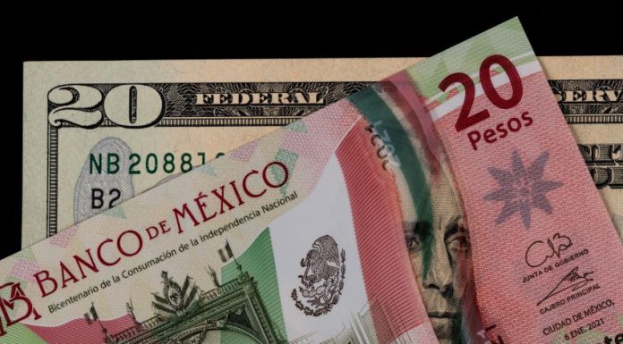 A Mexican 20-peso bill and a U.S. 20-dollar bill on an abstract black background. The Mexican bill is laying over the U.S. bill.