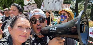 Tara Stamos-Buesig poses with supporters at a rally