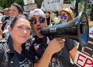 Tara Stamos-Buesig poses with supporters at a rally