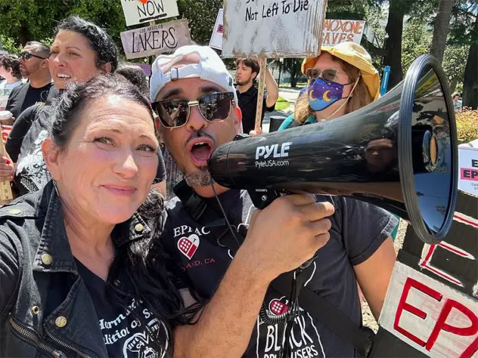 Tara Stamos-Buesig poses with supporters at a rally