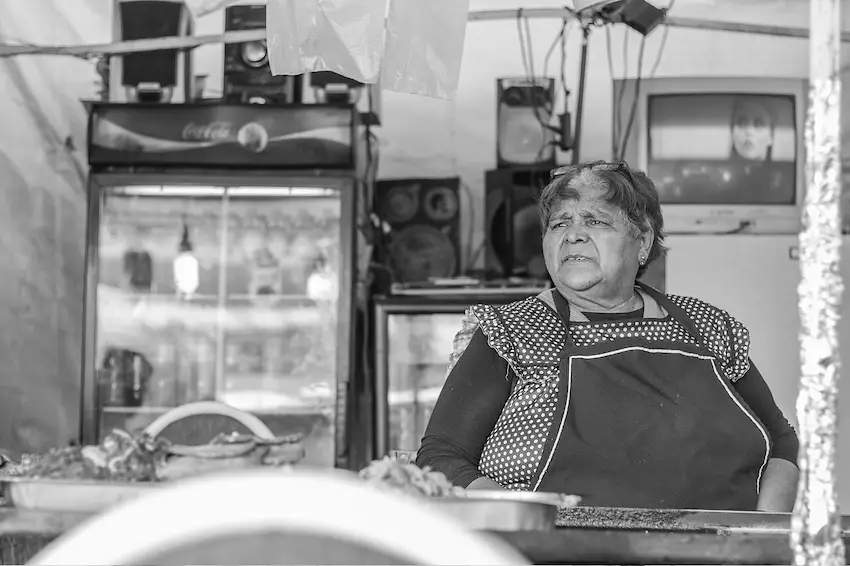 A grocery store owner in a typical 'tiendita mexicana'.