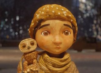 A stop animation still of a little boy in a scarf and and hat with a small owl on his shoulder from the Alfonso Cuaron short film "An Almost Christmas Story"