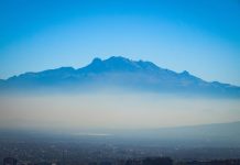 The Mexico City skyline with a layer of fog over it.