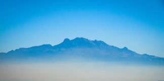 The Mexico City skyline with a layer of fog over it.