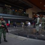 Soldiers stand guard outside a shooting crime scene in a Polanco neighborhood mall, in Mexico City