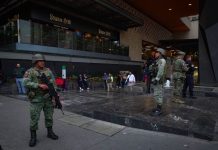 Soldiers stand guard outside a shooting crime scene in a Polanco neighborhood mall, in Mexico City