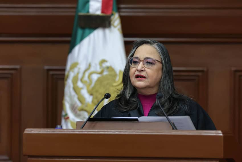 Mexico's Supreme Court Chief Justice Norma Pina standing at a podium giving the judiciary's annual report to the nation.