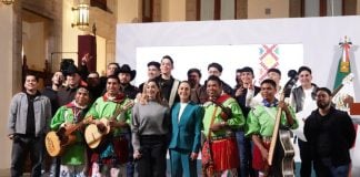 President Claudia Sheinbaum, front center, posing with a group of musicians in traditional Mexican indigenous clothing