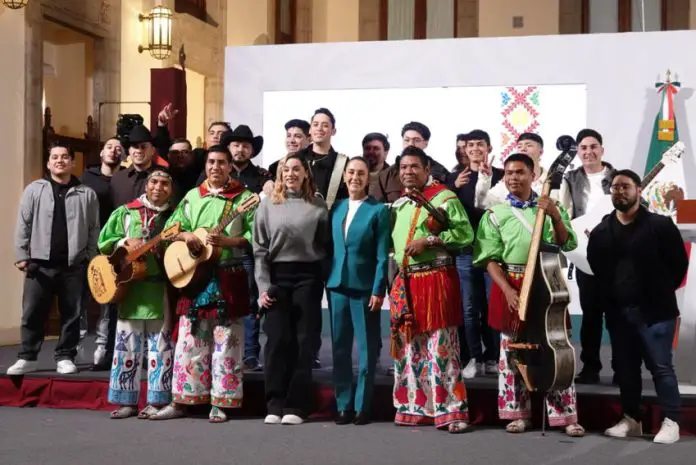 President Claudia Sheinbaum, front center, posing with a group of musicians in traditional Mexican indigenous clothing