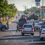 Police and security officials block the street of a crime scene in Culiacán, Sinaloa, where a federal agent was killed.