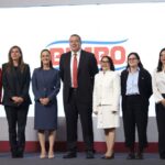 7 men and women standing on a stage
