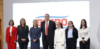 7 men and women standing on a stage