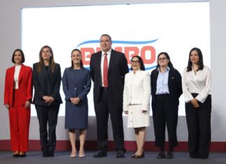 7 men and women standing on a stage