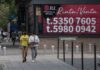 two people walkin gby a for rent sign