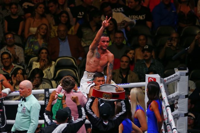 Mexican Gabriel Gollaz Valenzuela celebrates victory over Australian Steve Spark, during a boxing match held at the Akron Stadium in Zapopan.