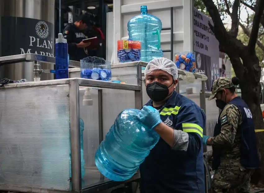 Un hombre sosteniendo un 'garrafón de agua', listo para ser entregado en México.