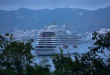 Cruise ship in Acapulco port, surrounded by the Acapulco city skyline