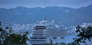 Cruise ship in Acapulco port, surrounded by the Acapulco city skyline