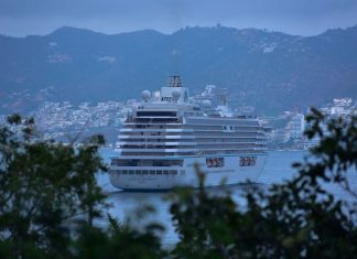 Cruise ship in Acapulco port, surrounded by the Acapulco city skyline