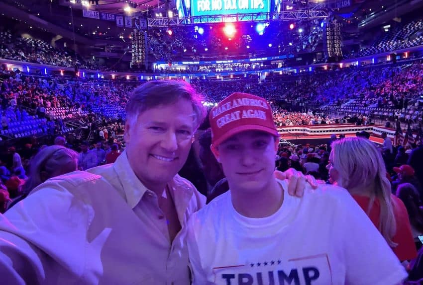 Landau with his arm around his son, who wears a MAGA cap. In the background is Madison Square Garden, filled with Trump supporters, and a a screen reading "vote Trump for no tax on tips."