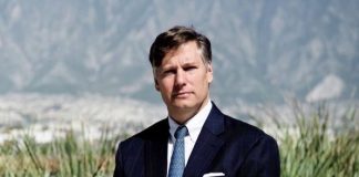 A portrait of former ambassador to Mexico Christopher Landau in the Mexican desert wearing a business suit