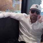 A photo of 'El Mini Lic' wearing sunglasses and a baseball cap in a US cafe, before he was arrested