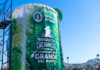 A massive 'Margarita Cachanilla' statue in Tijuana, Mexico. resembling an oversized cocktail cup, with the words "Guinness World Records Official Attempt" visible, promoting "La Margarita Más Grande del Mundo' (The World's Largest Margarita). The structure stands under a clear blue sky with the Tijuana skyline in the background.