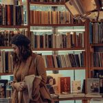 A woman browses books at a bookstore